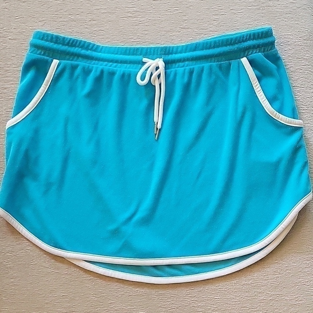 Turquise TERRYCLOTH mini skirt with white trim. Ties at waist. Size is 19 XXL